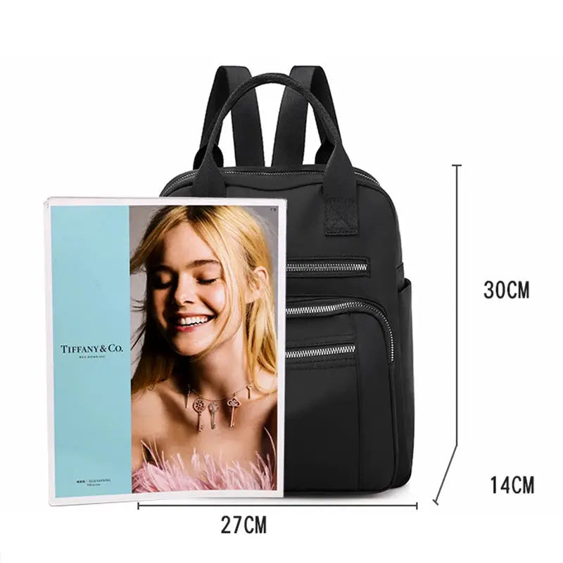 Backpack for women in black Oxford fabric with top handles and multiple zip pockets