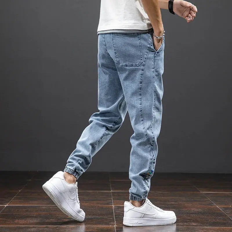 Blue denim cargo jogger pants for men with elastic cuffs.