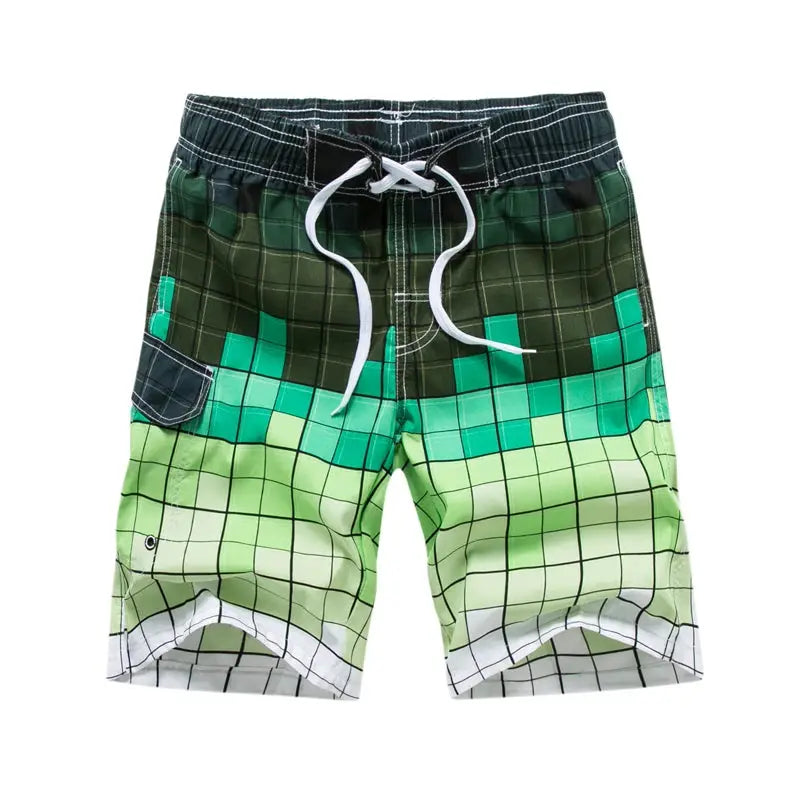 Men's surf board shorts, Simples Market, green gradient grid pattern with white drawstring.
