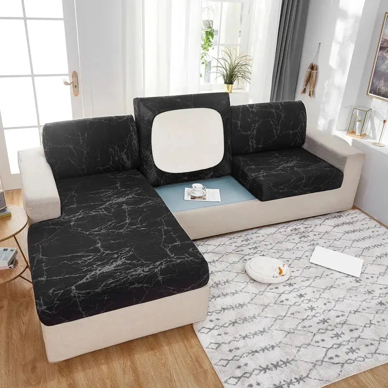 Geometric print corner sofa cover with elastic stretch, black marble-pattern cushions on beige sectional; pet protector.