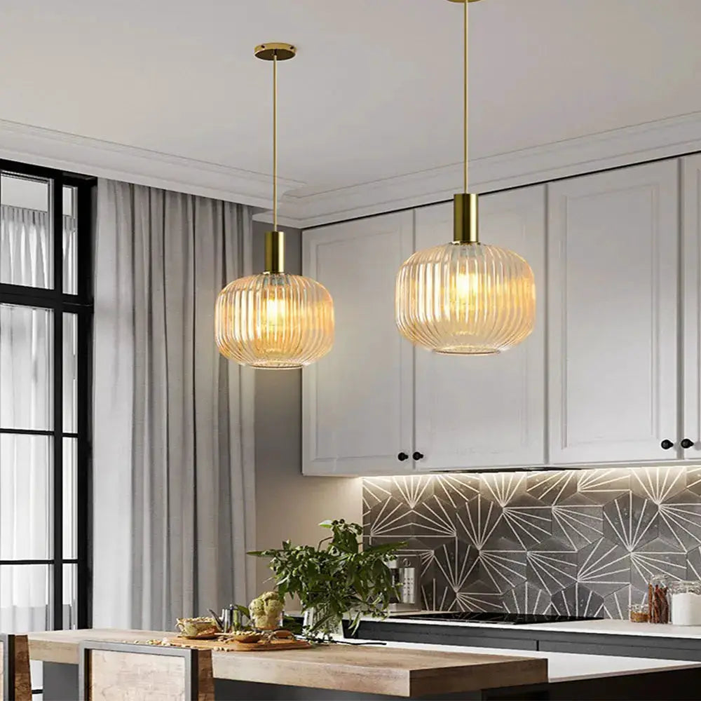 Retro glass pendant lights by Simples Market, colorful ribbed glass with brass canopy, two hanging lamps over island