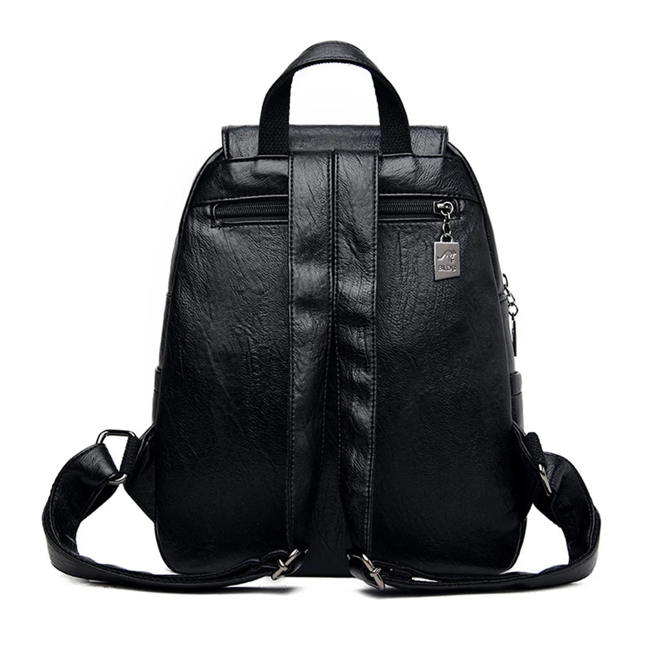 Black soft leather backpack with top handle and adjustable straps; front zip pockets.