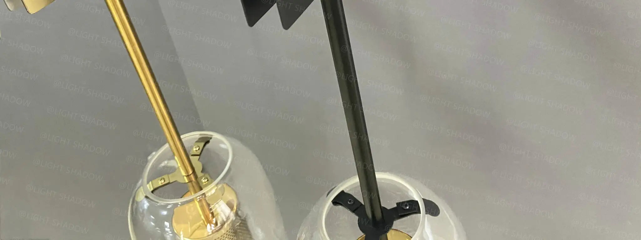 Modern glass wall light sconce, two pendant lamps with clear glass globes and gold and black mounts, Simples Market.
