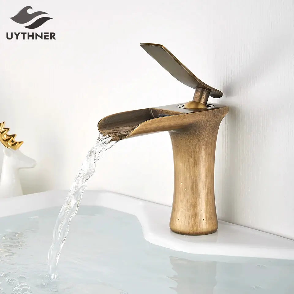 Waterfall basin faucet with antique-brass finish, single-handle lever by Simples Market for bathroom sink.