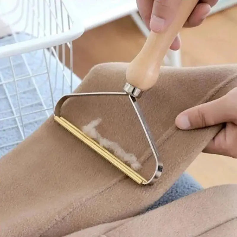 Portable lint remover tool with wooden handle removing lint from camel coat fabric