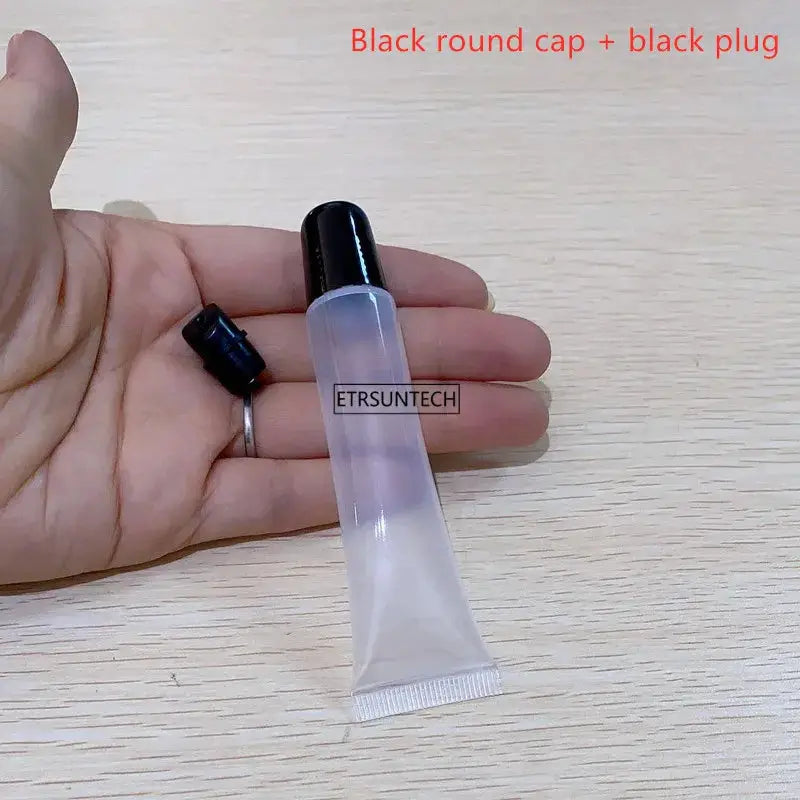 Clear lipstick tube with black cap, empty cosmetic squeeze bottle