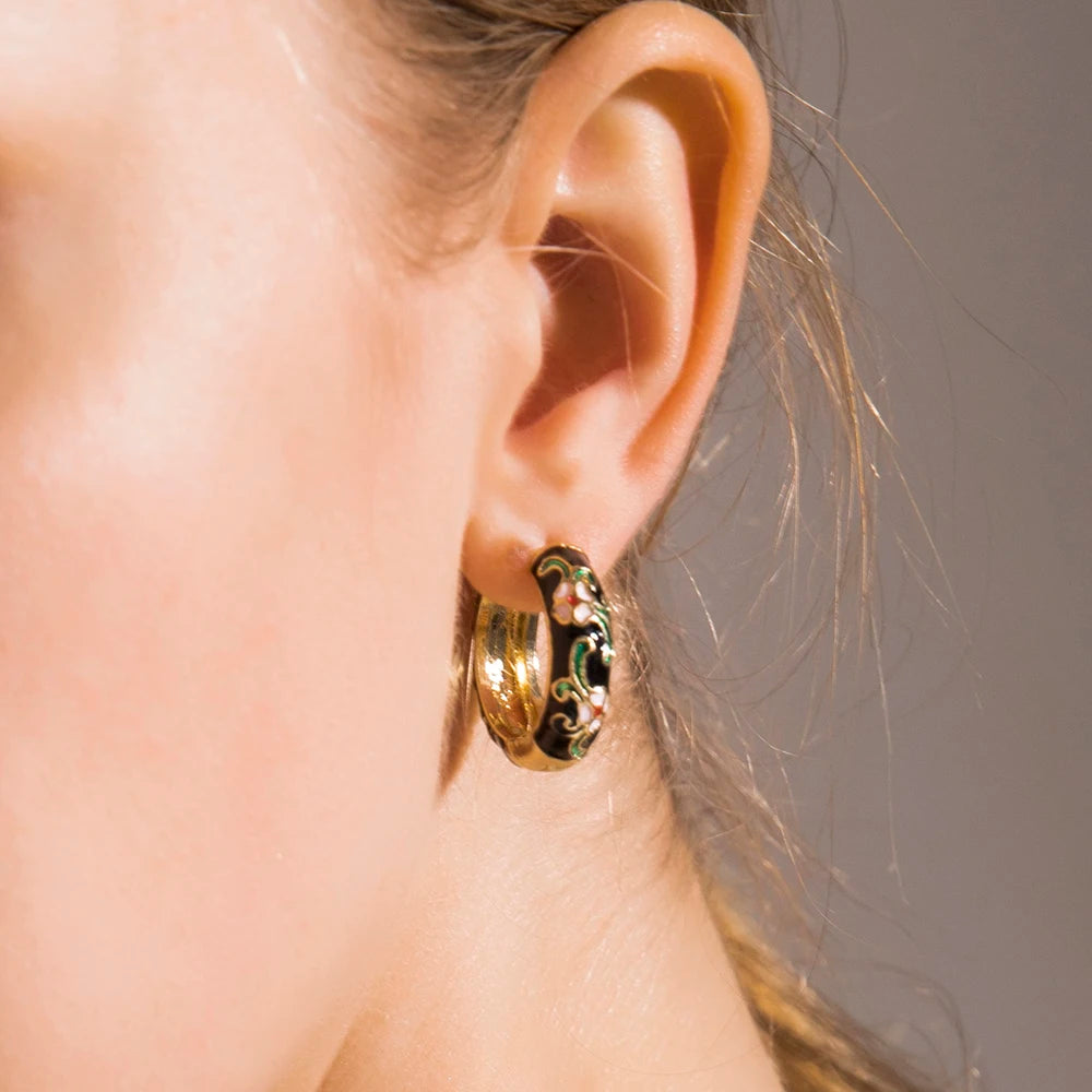 Enamel flower huggie hoops by Simples Market, gold-tone with green enamel accents, vintage boho pair