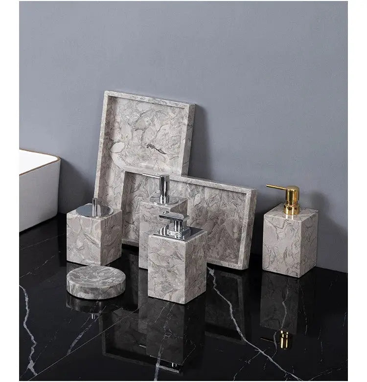 Bathroom accessories set by Simples Market in gray marble; includes soap dispenser, toothbrush holder, cup, soap dish.