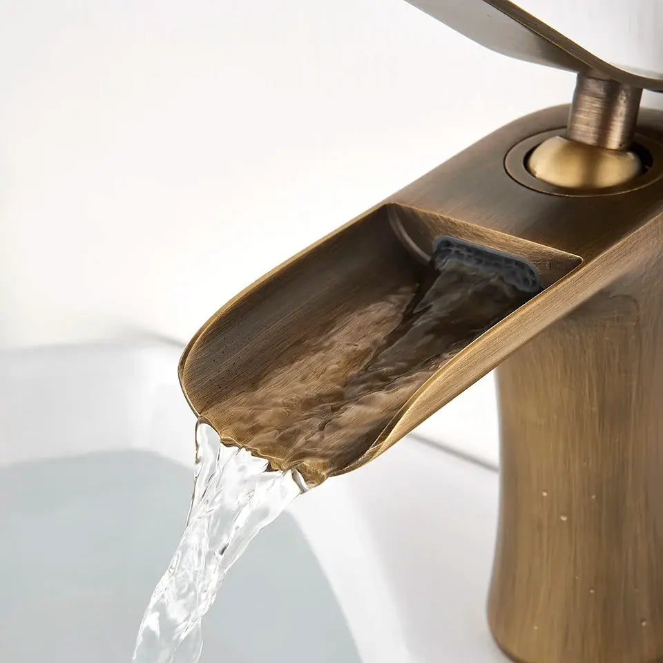 Antique brass basin waterfall bathroom faucet with a single-handle design