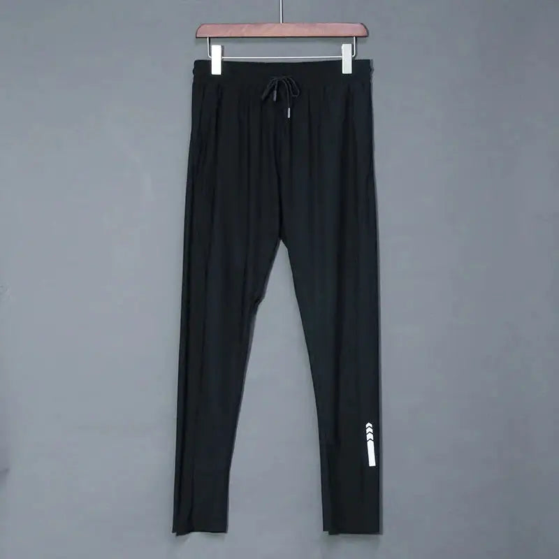 Black men's running jogger pants with elastic waistband, drawstring, and reflective stripe.