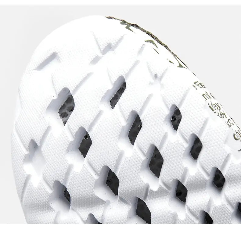 White water shoe outsole with diamond-shaped perforations and textured grip