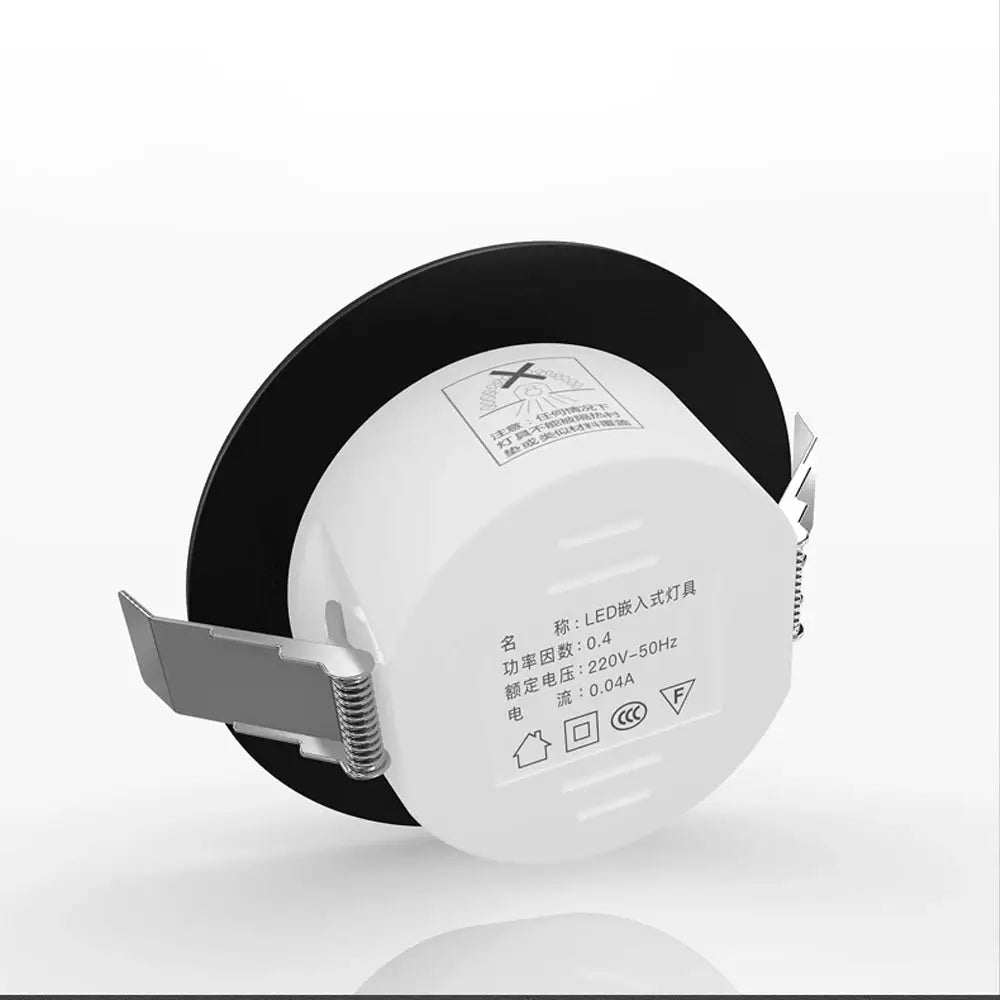 Chrome round recessed LED downlight with white acrylic body and metal spring clips for ceiling mounting