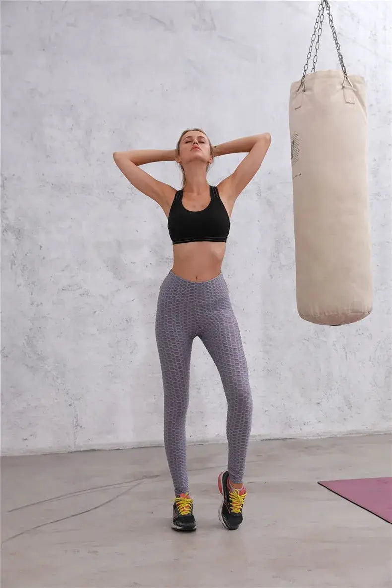 Push Up leggings for women, high-waist gray honeycomb-pattern gym tights worn with a black sports bra.