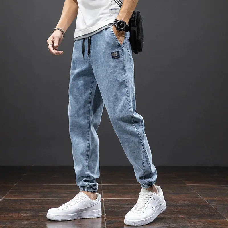 Men's cargo denim jogger jeans in light blue with drawstring waist and elastic cuffs