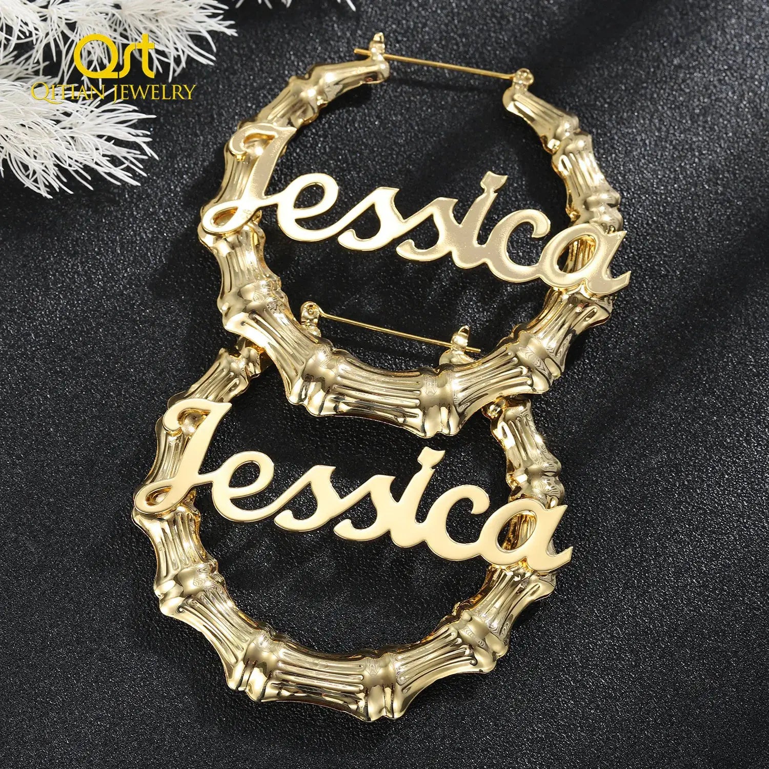 Gold-tone bamboo hoop earrings with a scripted custom name across the front; set of 2
