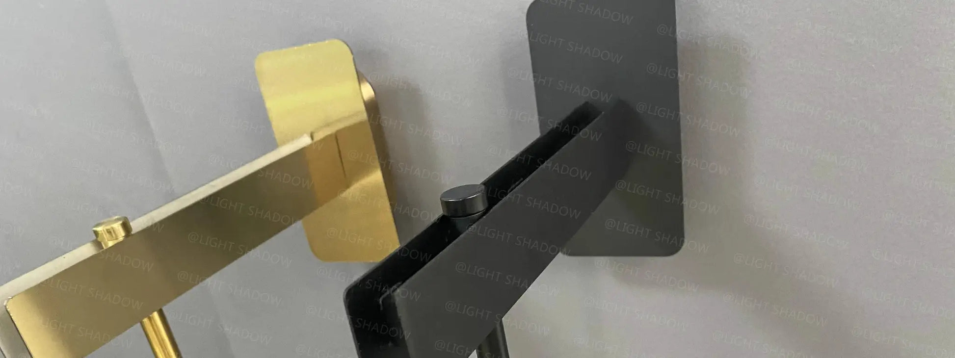 Modern glass wall light sconce with black metal frame and gold accent LED luminaire