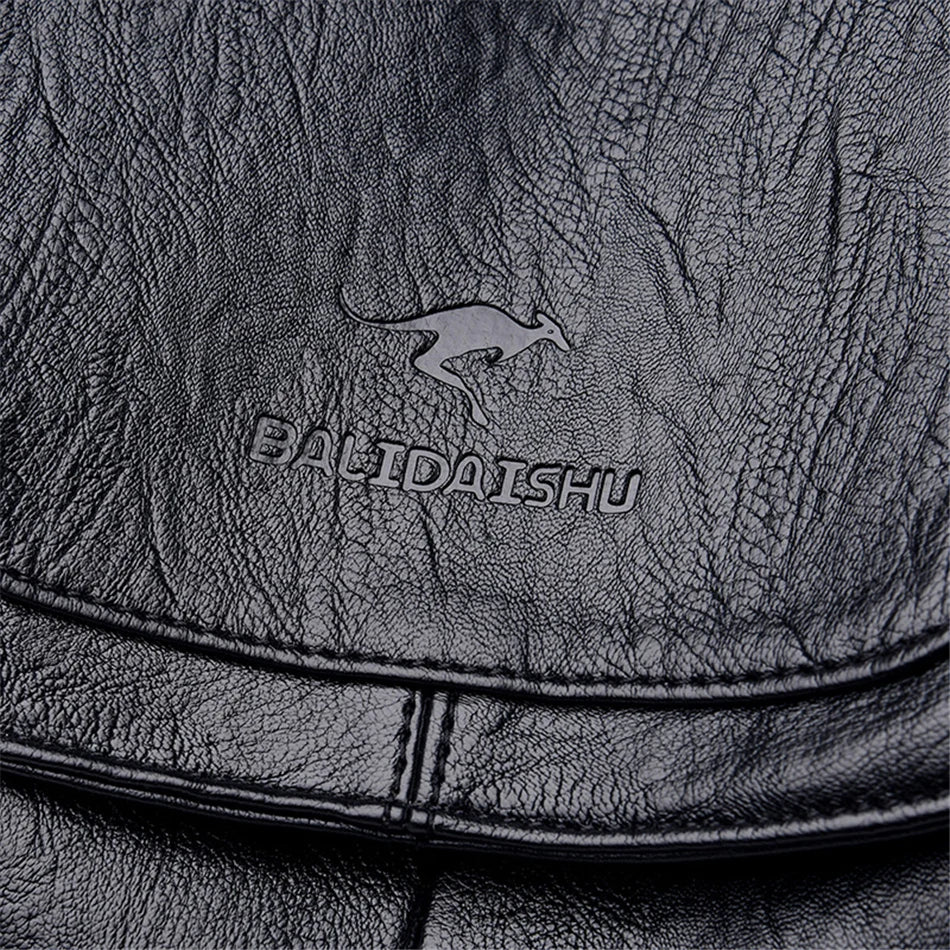 Leather backpack by BALDIAISHU; black soft leather with embossed logo.