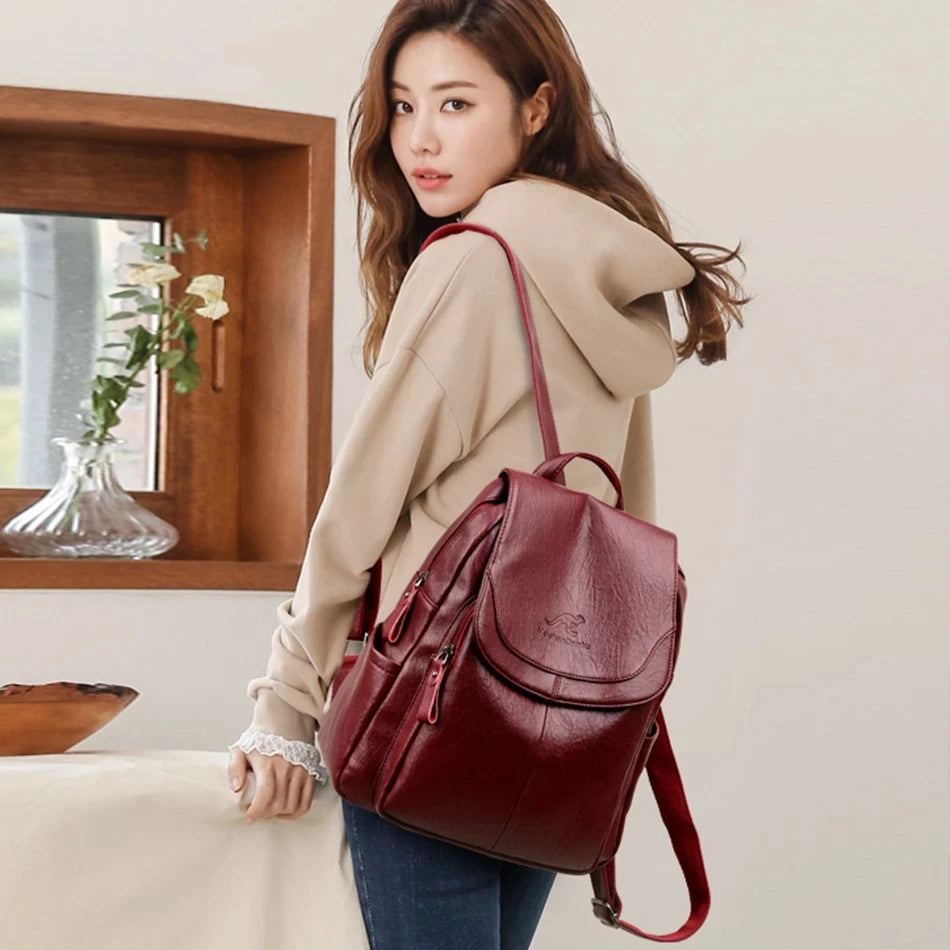 Genuine Women Soft Leather Backpack by Simples Market, burgundy leather with curved front flap.