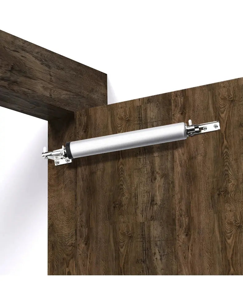 KAK soft-closing door closer, silver pneumatic cylinder mounted on wooden door