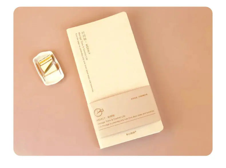 Kinbor weekly planner notebook with cream cover; undated agenda on peach background