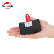 Naturehike pocket beach mat in black with red carry loop, compact folded picnic blanket