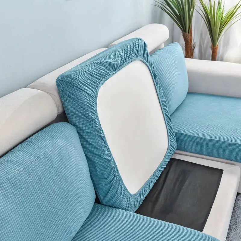 Sofa seat cushion cover in blue stretch fabric; removable, washable slipcover.