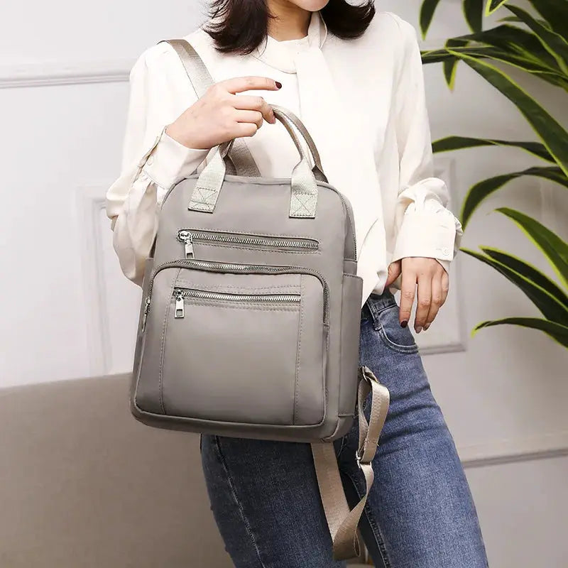 Simples Market women's gray waterproof Oxford backpack with multiple zip pockets and top handles
