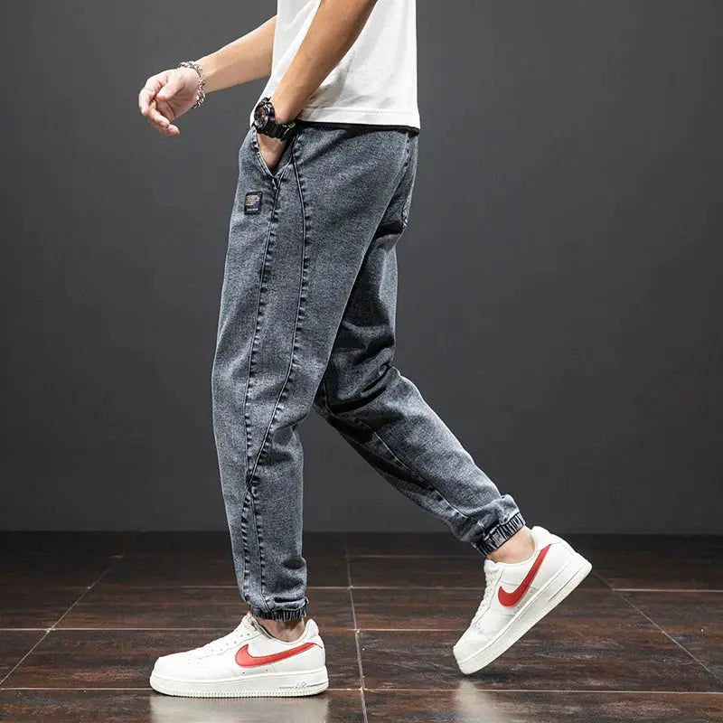 Men's cargo denim jogger pants in blue-gray by Simples Market, baggy harem style with cuffed ankles.