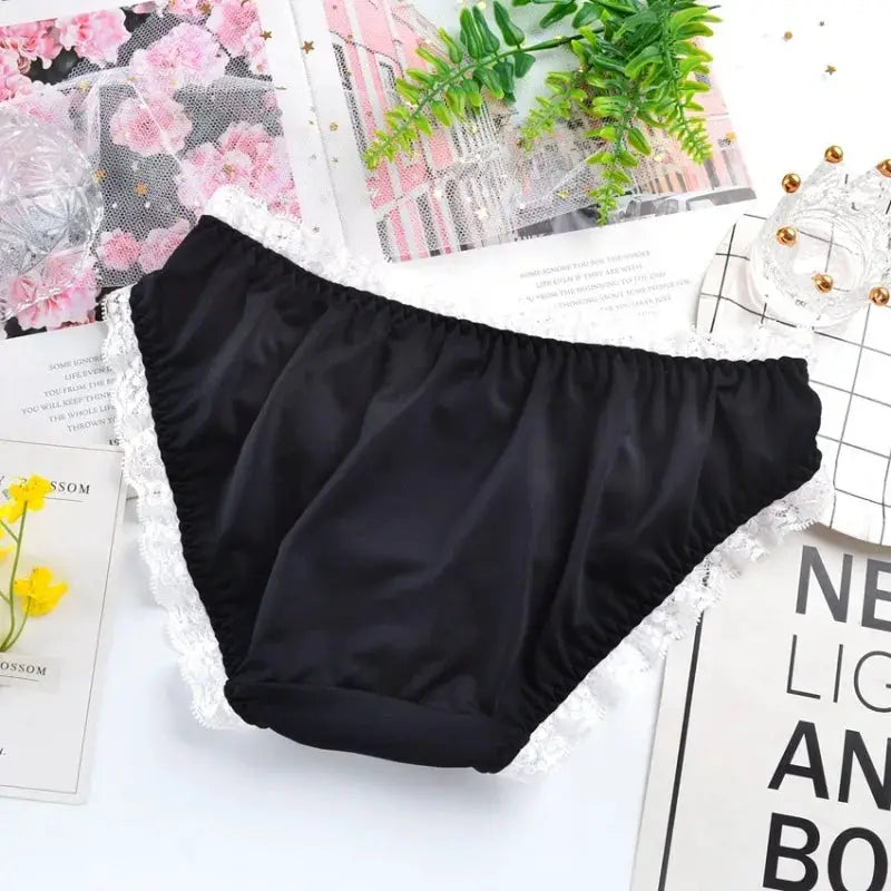 Panties: black milk-silk underwear with white lace trim, low-waist briefs.