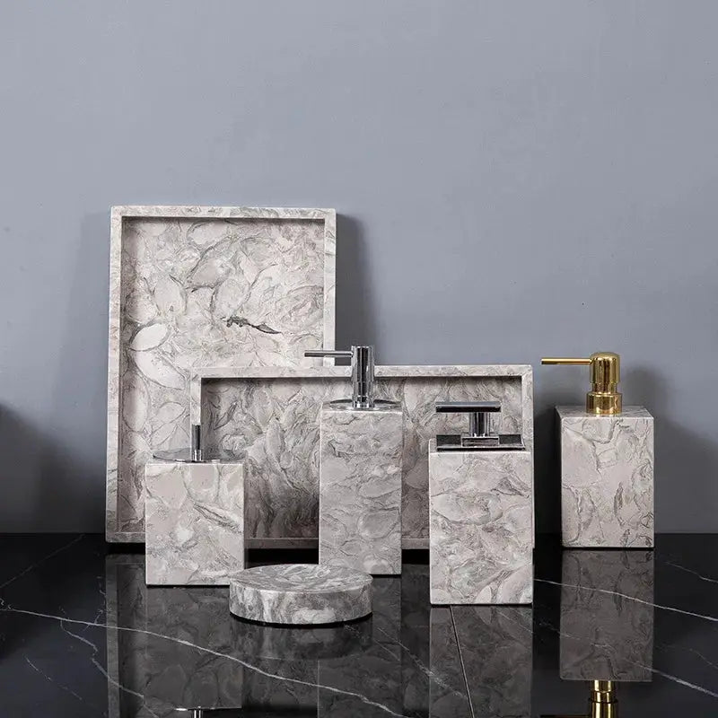 Simples Market gray marble bathroom set with gold pump soap dispenser, toothbrush holder, cup, and soap dish.
