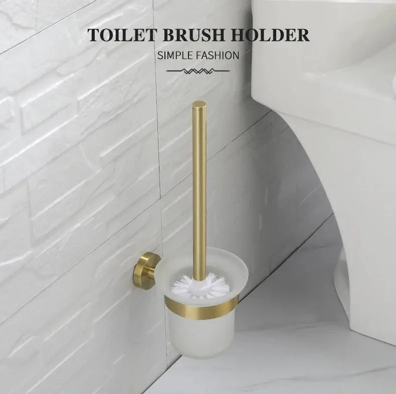 Toilet brush holder set in brushed gold with wall-mount bracket and white cup.
