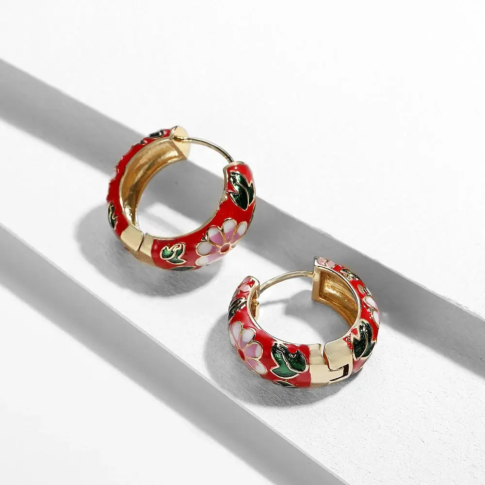 Pair of red enamel floral huggie hoop earrings with gold-tone trim