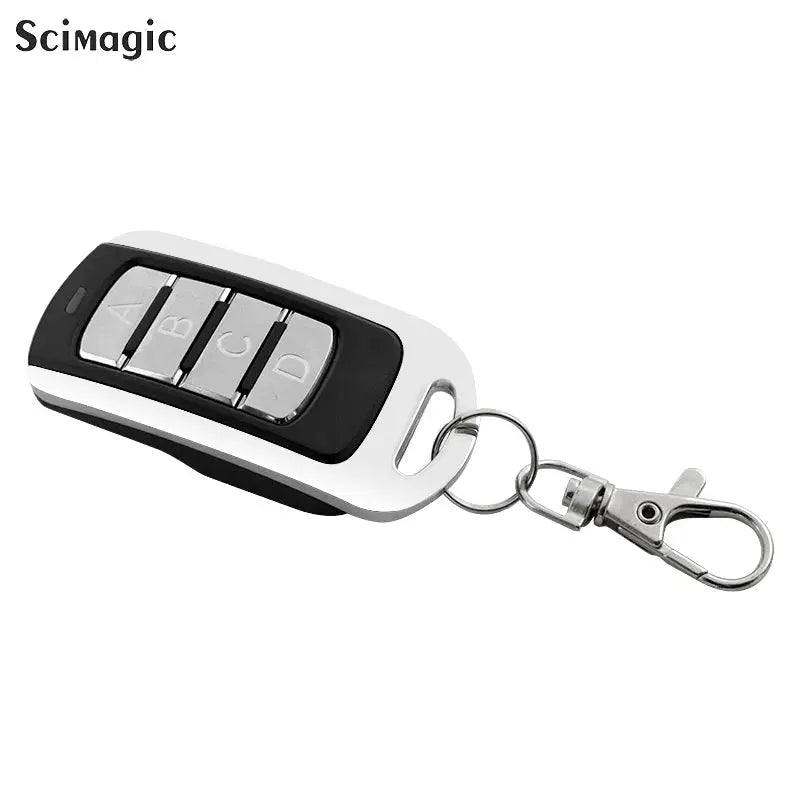 4-button garage remote key fob with white body, black inset and silver A/B/C/D buttons on a metal key ring