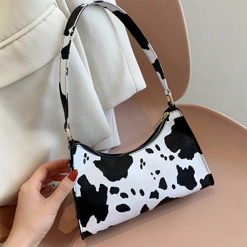 Simples Market cow-print PU leather shoulder bag with black and white pattern and gold hardware