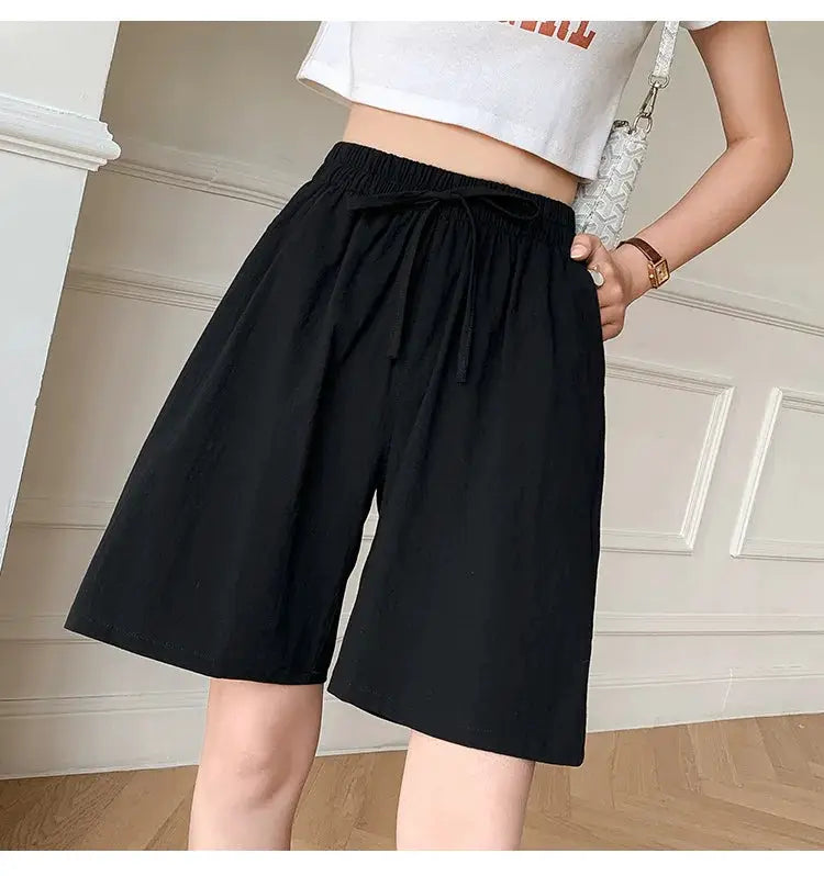Women's black cotton shorts with high waist, drawstring, and two pockets; loose casual fit.