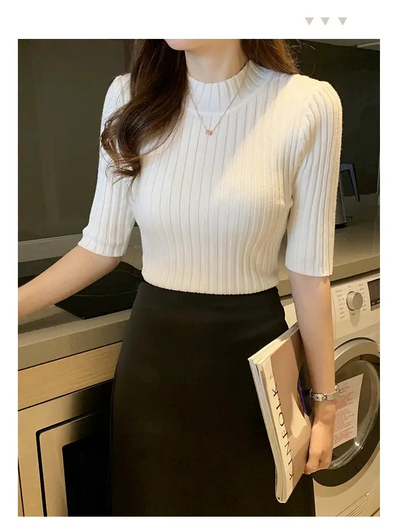 White ribbed knit blouse by Simples Market, crew neck with short sleeves, styled with a black skirt.