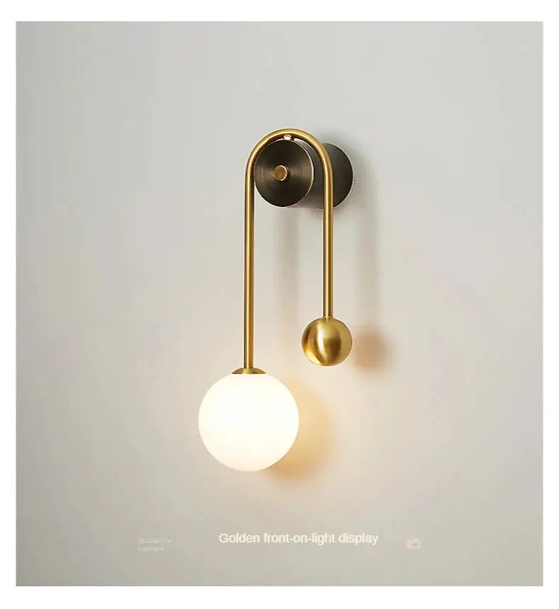 Gold wall lamp with glass ball shade and LED light, modern Nordic sconce.