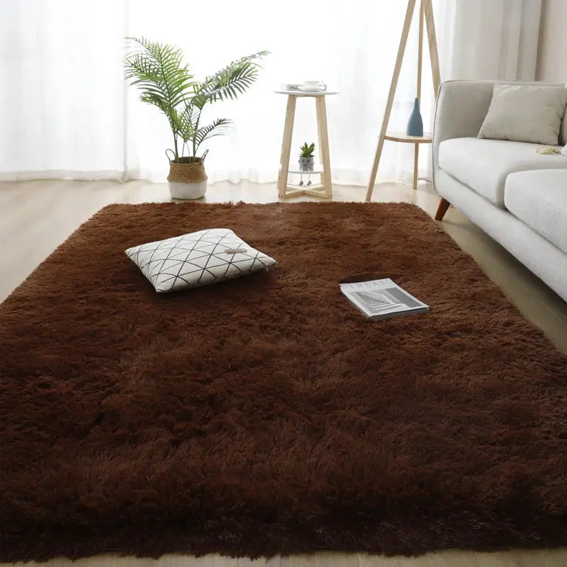 Brown fluffy long-pile shag rug 160x230 for living room, with sofa and plant nearby.