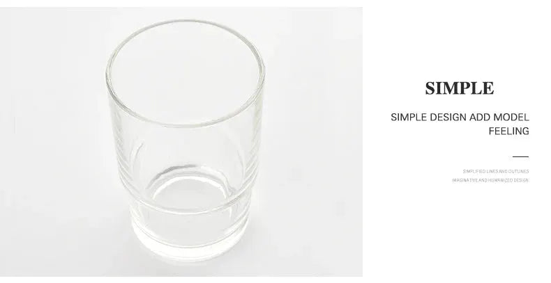 Clear glass bathroom tumbler with subtle etched pattern on white background.