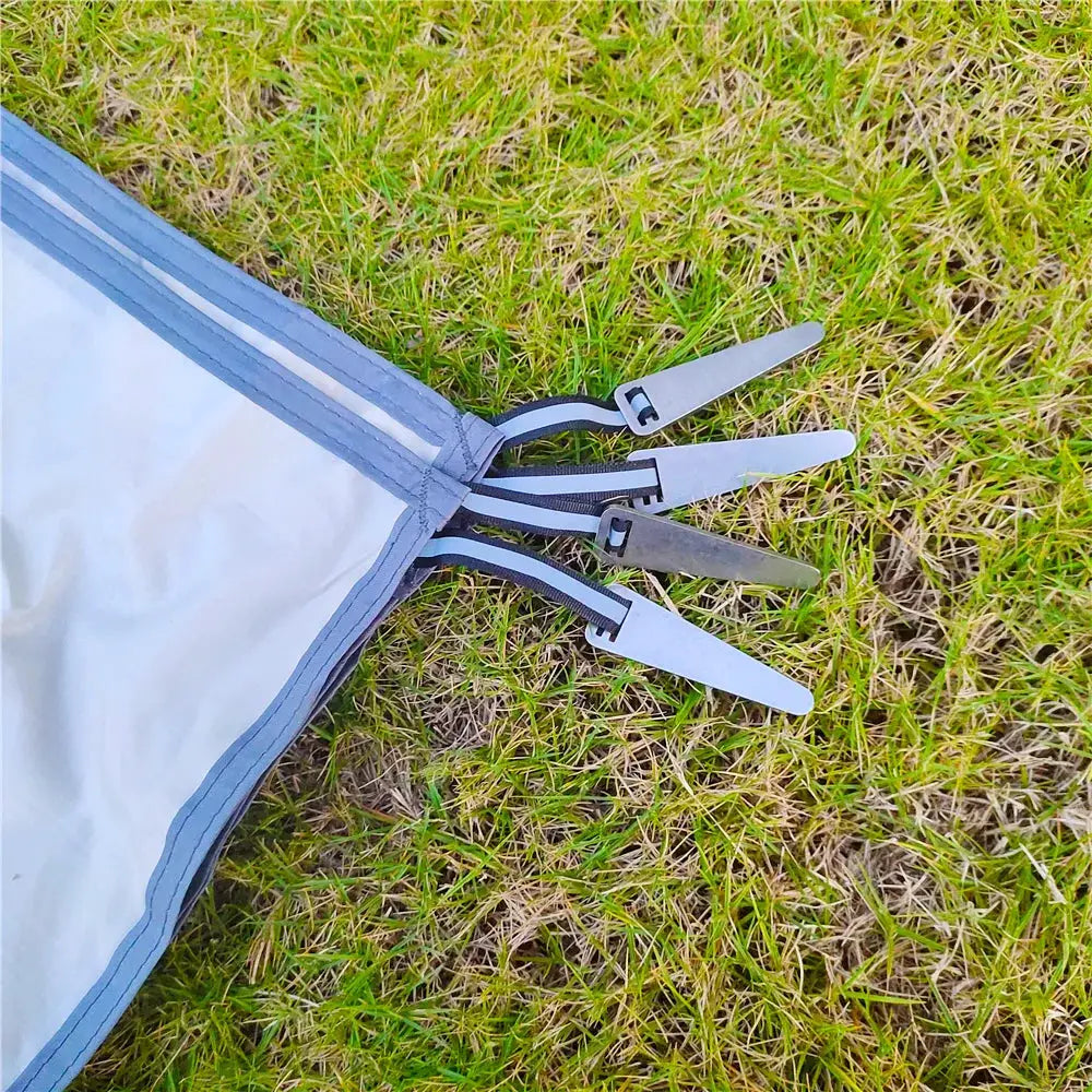 Waterproof camping mat with pegs; gray fabric with blue trim, ultralight portable travel beach mat