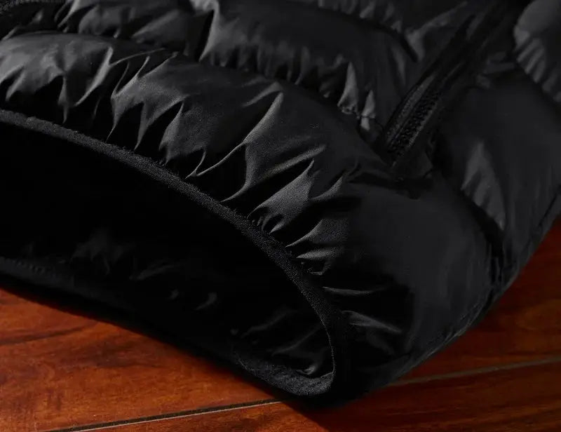 Black padded men's sleeveless vest with quilted warmth and zipper
