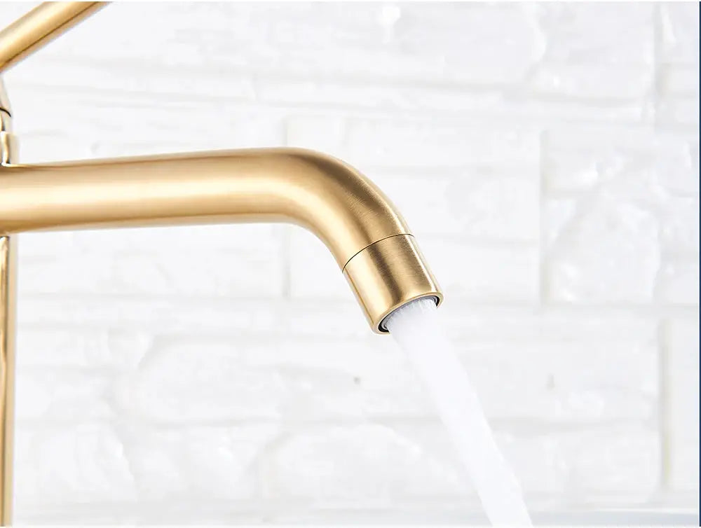 Brushed gold basin faucet with curved spout and running water