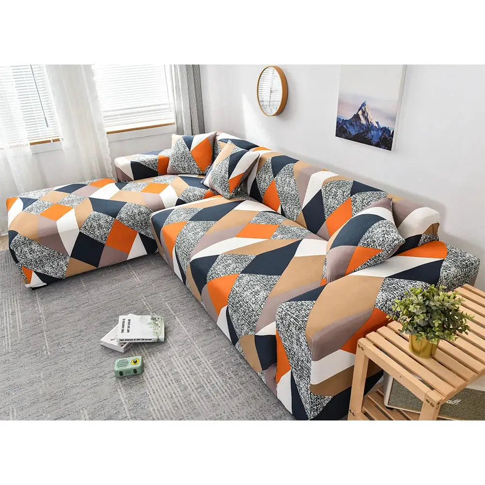 Sofa slipcover by Simples Market with elastic geometric pattern on an orange, navy, beige and white L-shaped sofa.