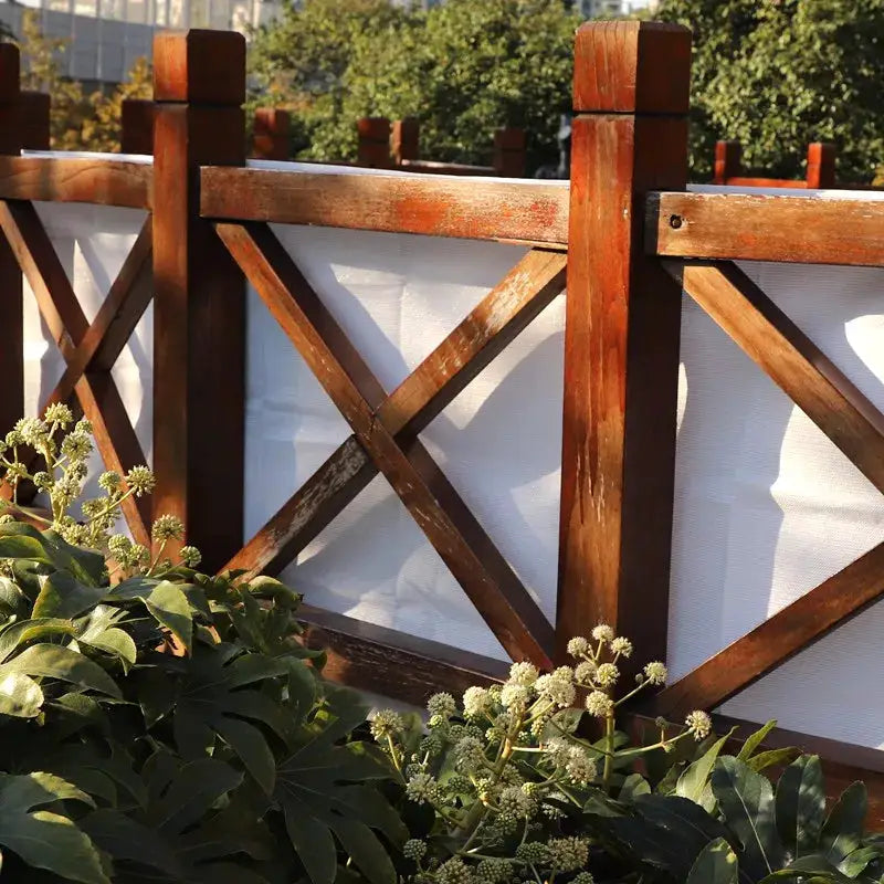 Tewango sun shade net on a wooden garden fence; anti-UV HDPE, 95% shade for privacy