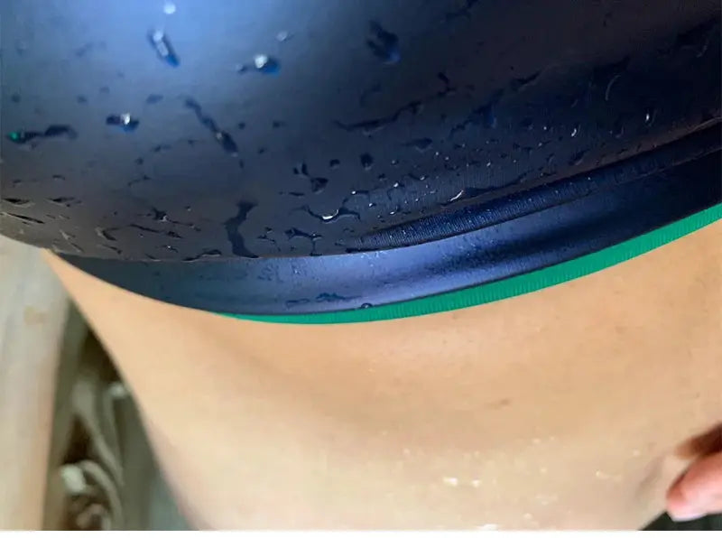 Neoprene sauna vest waist trainer in dark blue with green trim; close-up on sweaty torso.