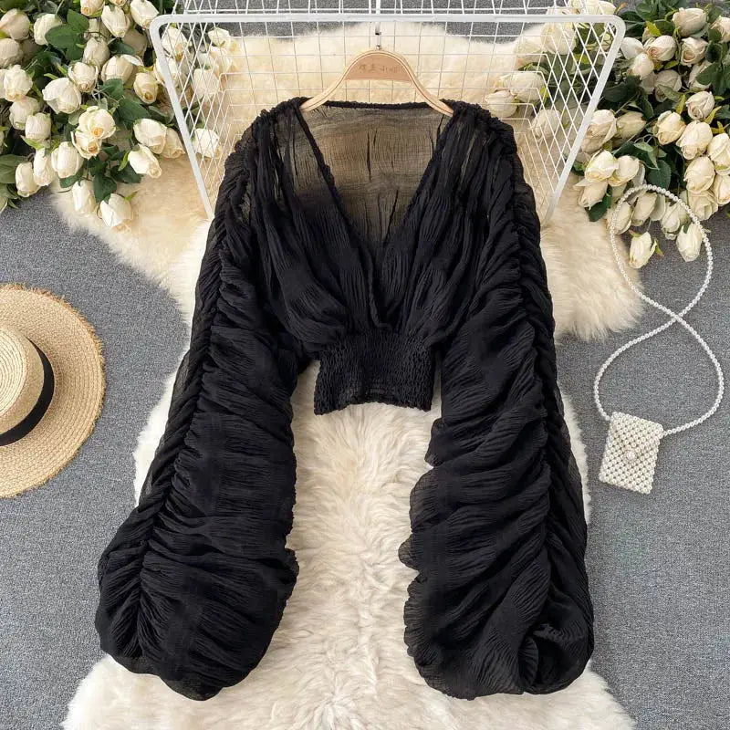Draped chiffon blouse in black by Simples Market with V-neck and puff long sleeves.
