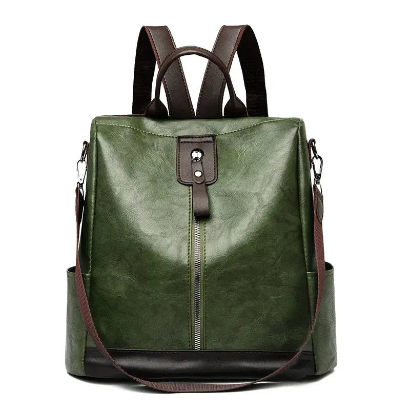 Backpack in green PU leather with brown straps, anti-theft design, front vertical zipper
