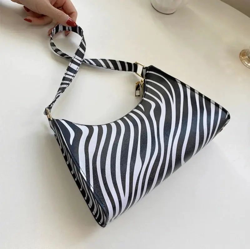Shoulder bag by Simples Market in zebra print PU leather with adjustable striped strap