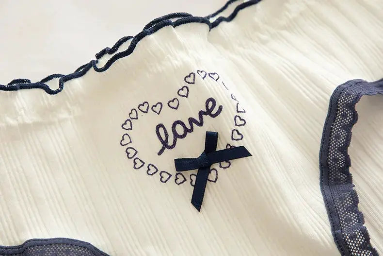 Cotton women's underwear with navy lace trim and bow, love embroidery on white fabric