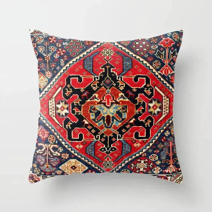 Pillow cover by Simples Market; Moroccan-inspired Bohemian geometric pattern in red, blue, and gold.